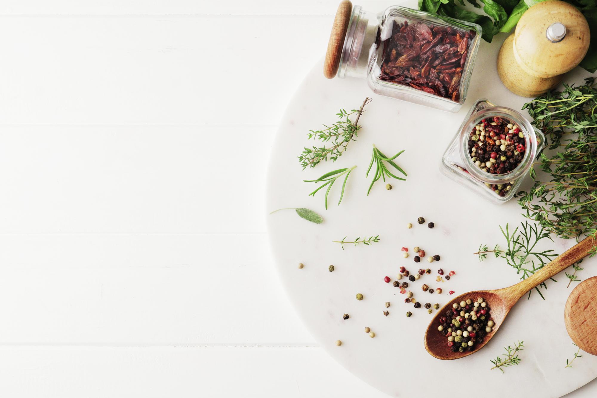 Close-up of herbs and spices on white table